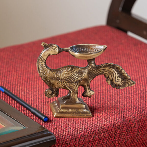 Glowing Peacock' Hand-Etched Carved Diya In Brass (730 grams) Glowing Peacock' Hand-Etched Carved Diya In Brass (730 grams)