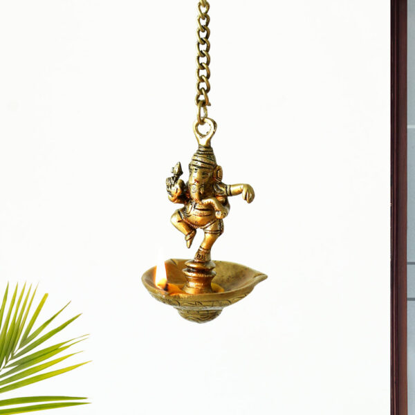 Handcarved 'Dancing Ganesh' Brass Hanging Diya (3 Wicks, 25 ml, 520 grams, Hand-Etched) Handcarved 'Dancing Ganesh' Brass Hanging Diya (3 Wicks, 25 ml, 520 grams, Hand-Etched)