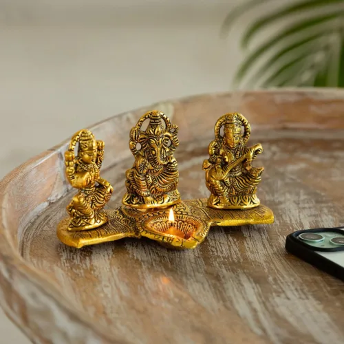 'Laxmi Ganesh & Saraswati' Idol Showpiece Figurine with Diya (1 Wick, 9.4 cm, Golden, Metal, Handcrafted) 'Laxmi Ganesh & Saraswati' Idol Showpiece Figurine with Diya (1 Wick, 9.4 cm, Golden, Metal, Handcrafted)