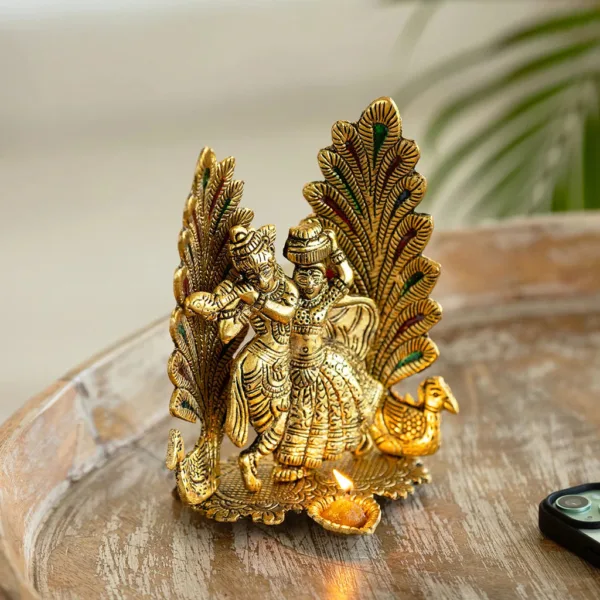 'Radha-Krishna & Peacock' Idol Showpiece Figurine with Diya (1 Wick, 17.5 cm, Golden, Metal, Handcrafted) 'Radha-Krishna & Peacock' Idol Showpiece Figurine with Diya (1 Wick, 17.5 cm, Golden, Metal, Handcrafted)